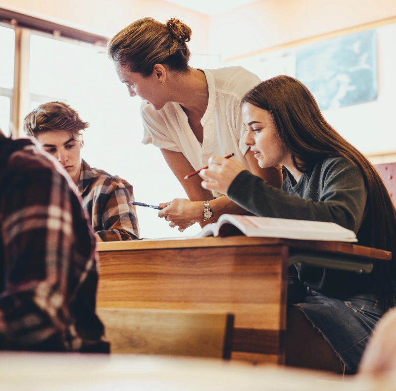 A group of students in a classroom with a teacher.