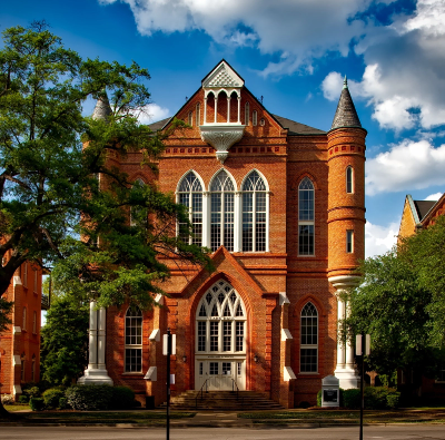 A red brick building on a street corner.