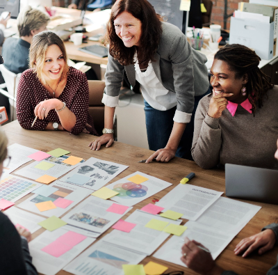 A group of people sitting around a table in an office.