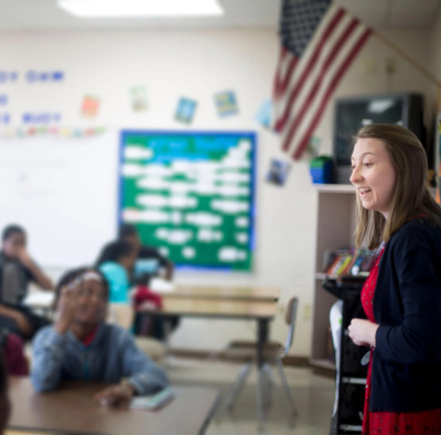 A teacher standing in front of a classroom.