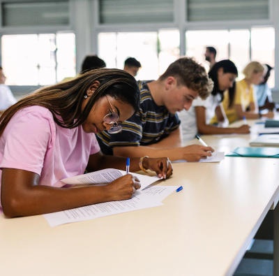 A group of students taking a test in a classroom.